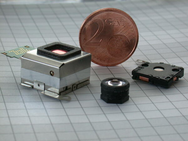 Camera for cell phone with moving lens assembly.